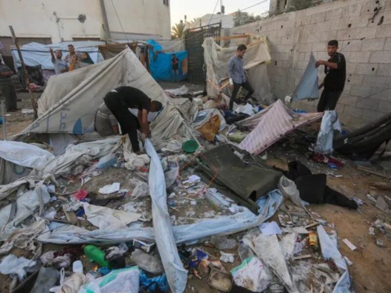 Palestinians examine tents destroyed in an Israeli attack around the Al-Aqsa Martyrs Hospital in Deir el-Balah, central Gaza, on September 27