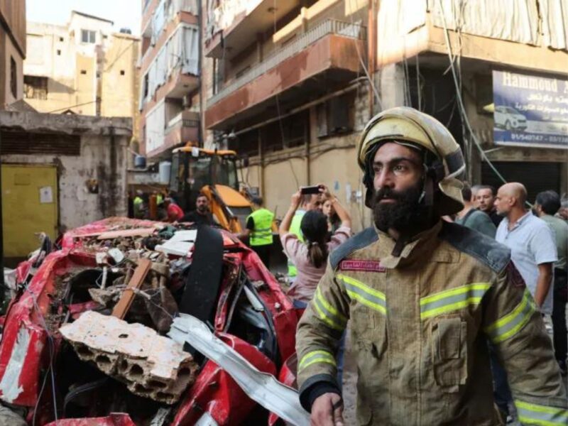 A firefighter works at the site of an Israeli attack, in Beirut's southern suburbs