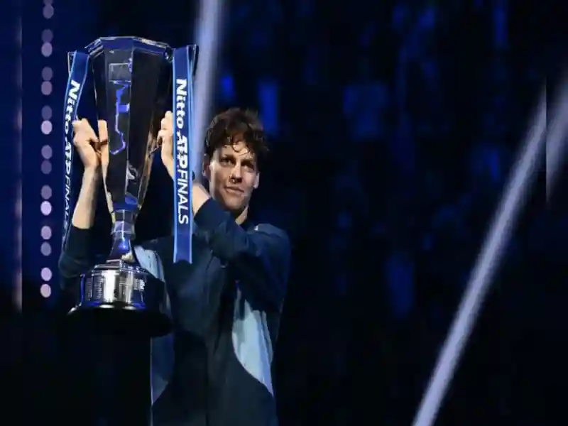 Jannik Sinner poses with the trophy