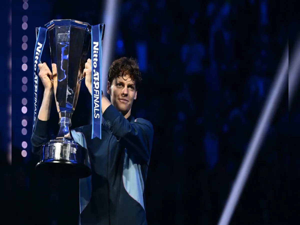 Jannik Sinner poses with the trophy