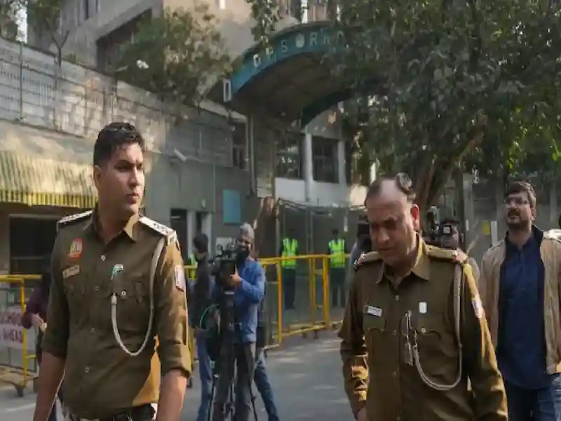 Police personnel outside DPS RK Puram during an investigation after the school received bomb threat in New Delhi.