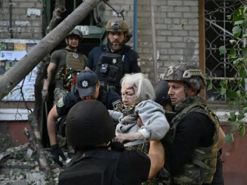 An elderly woman is helped by police after Russia bombed an apartment block in Kramatorsk