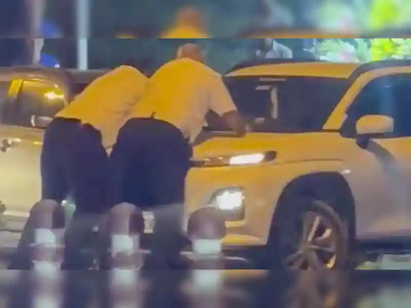 The Traffic Cops Were Hanging On The Car'S Bonnet But The Driver Did Not Stop